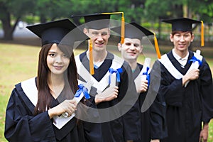 students in graduation gowns on university campus