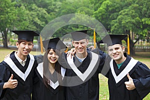 students in graduation gowns on university campus