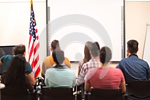 Students in hall sitting back view