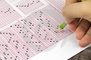 Students hand doing exams quiz test paper