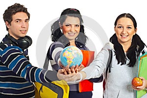 Students with hands together holding globe