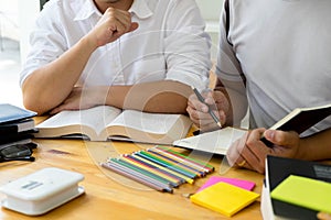 Students helps friend teaching and learning subject additional in library. Education concept