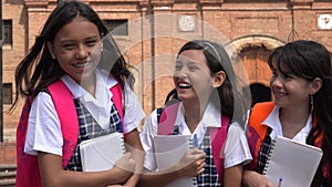 Girl Students Holding Notebooks Wearing School Uniforms photo