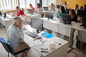 Students at an informatics exam photo