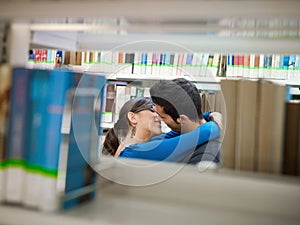 Students kissing in library