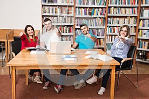 Students In A Library Showing Thumbs Up