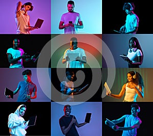 Young motivated emotional women and man demostrate tablet screen, using gadget over light and dark neon backgrounds. Job photo