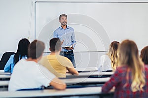 Students listening to professor in the classroom on college