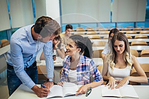 Students listening to professor in the classroom on college