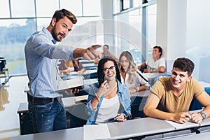 Students listening to professor in the classroom on college photo