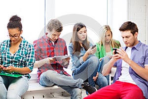 Students looking into devices at school