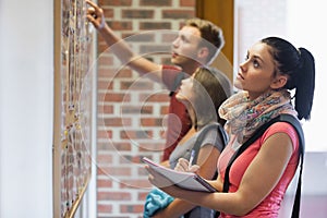 Students looking at notice board