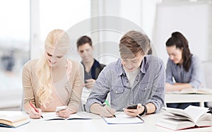 Students looking into smartphone at school