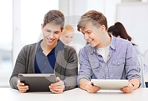 Students looking at tablet pc in lecture at school