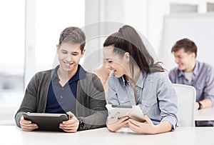 Students looking at tablet pc in lecture at school