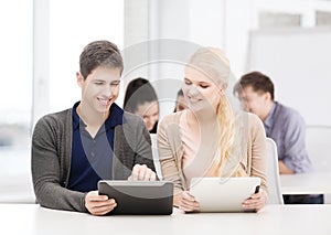 Students looking at tablet pc in lecture at school