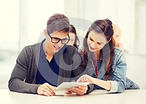 Students looking at tablet pc in lecture at school