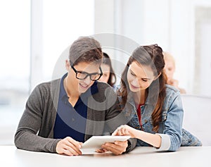 Students looking at tablet pc in lecture at school