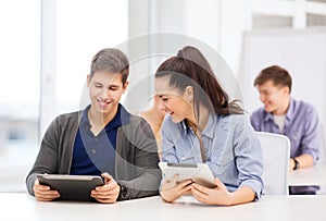 Students looking at tablet pc in lecture at school