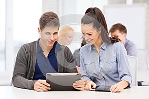 Students looking at tablet pc in lecture at school