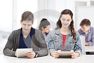 Students looking at tablet pc in lecture at school