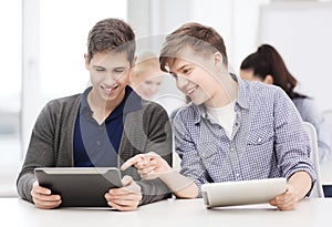 Students looking at tablet pc in lecture at school