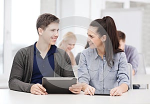 Students looking at tablet pc in lecture at school