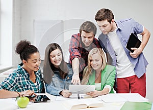 Students looking at tablet pc at school