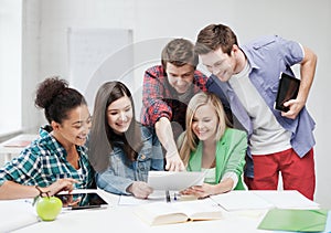 Students looking at tablet pc at school