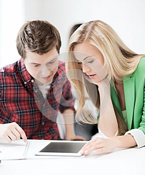 Students looking at tablet pc at school