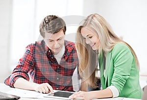 Students looking at tablet pc at school