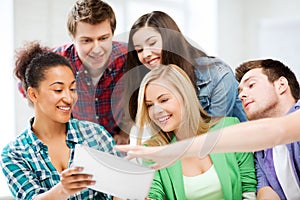 Students looking at tablet pc at school