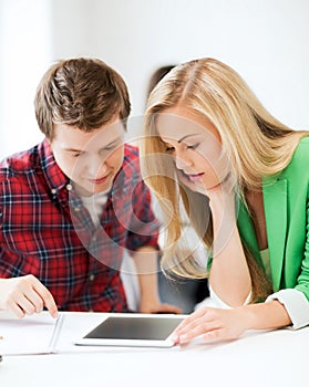Students looking at tablet pc at school
