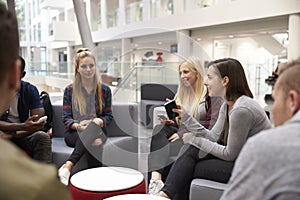 Students meeting in the foyer of modern university building