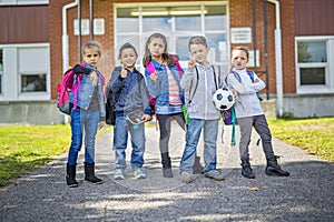 Students outside school standing together