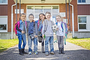 Students outside school standing together