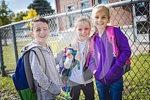 Students outside school standing together