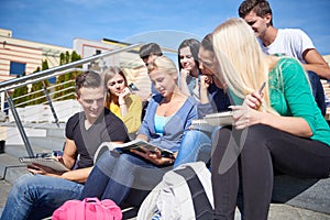 Students outside sitting on steps