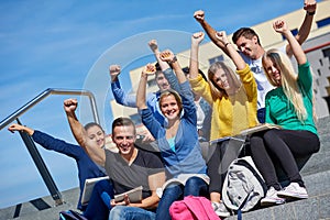 Students outside sitting on steps