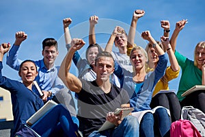 Students outside sitting on steps