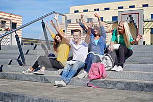 Students outside sitting on steps