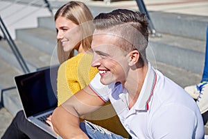 Students outside sitting on steps