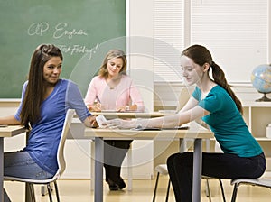 Students passing notes in classroom