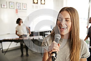 Students At Performing Arts School Playing In Band At Rehearsal