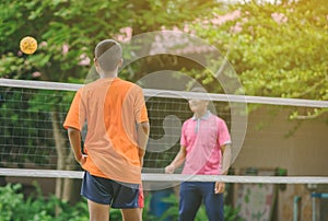 Students playing traditional asian sport game sepak takraw