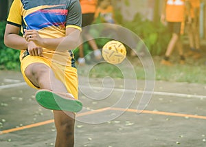Students playing traditional asian sport game sepak takraw