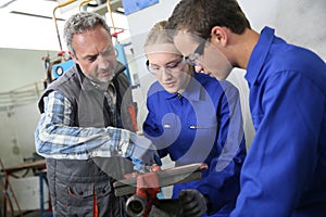 Students of plumbery with instructor