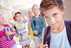 Students, portrait and boy with smile in hallway with education, study or backpack for back to school. Youth, young kid