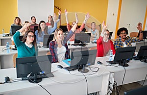 Students raising hand in class on university campus