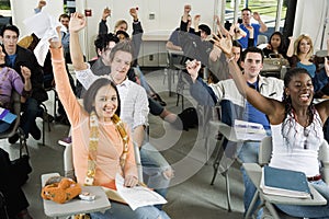 Students Raising Hands In The Classroom